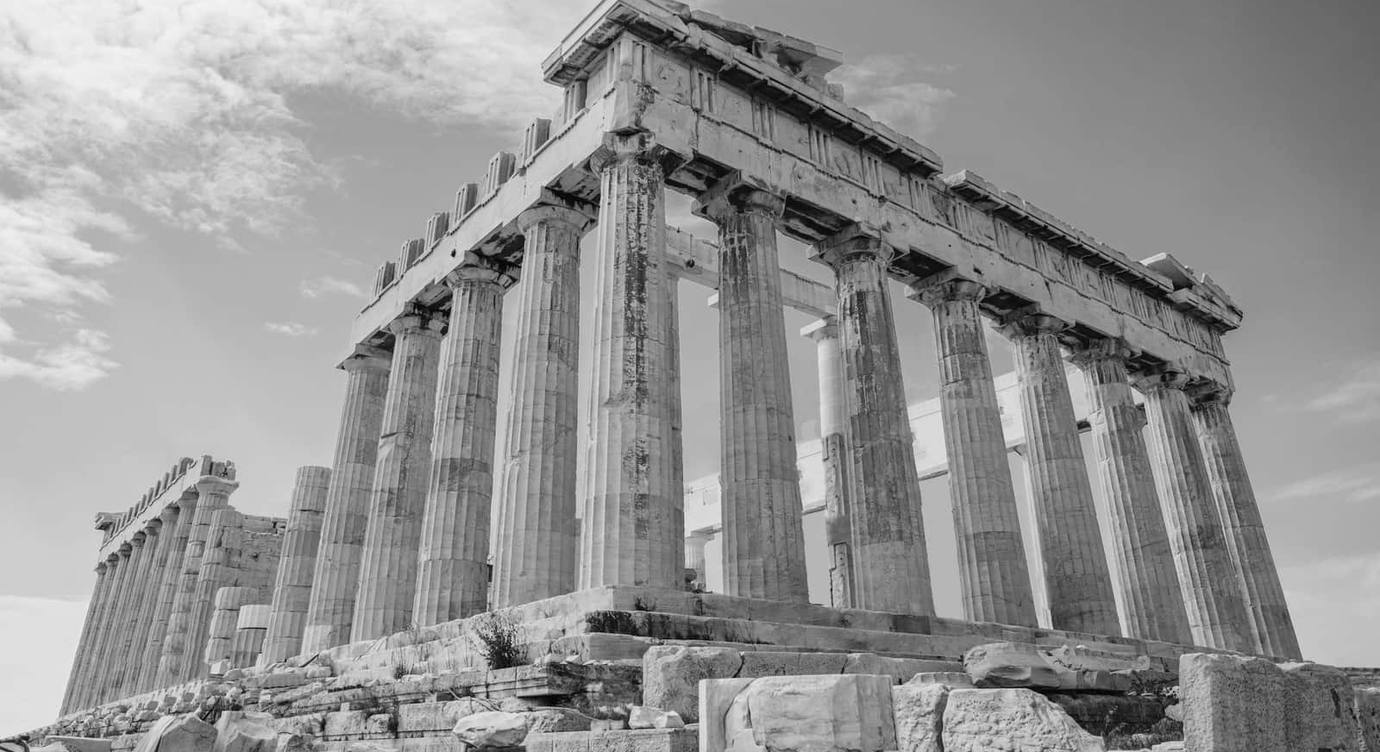 The Parthenon on the Acropolis in Athens, photographed from below in black and white.
